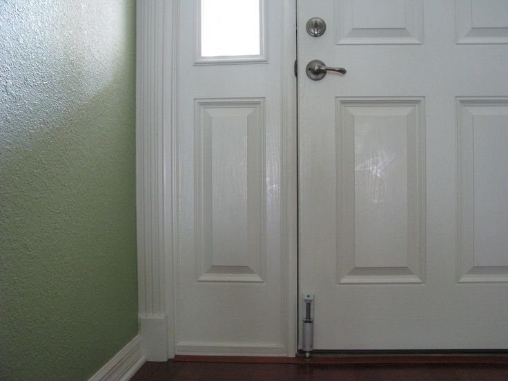 Steel cylinder attached to bottom of door, inserted into the floor, safely out of reach of a burglar's hands.